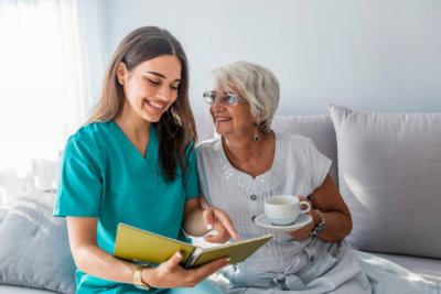 caregiver reads a book to a patient