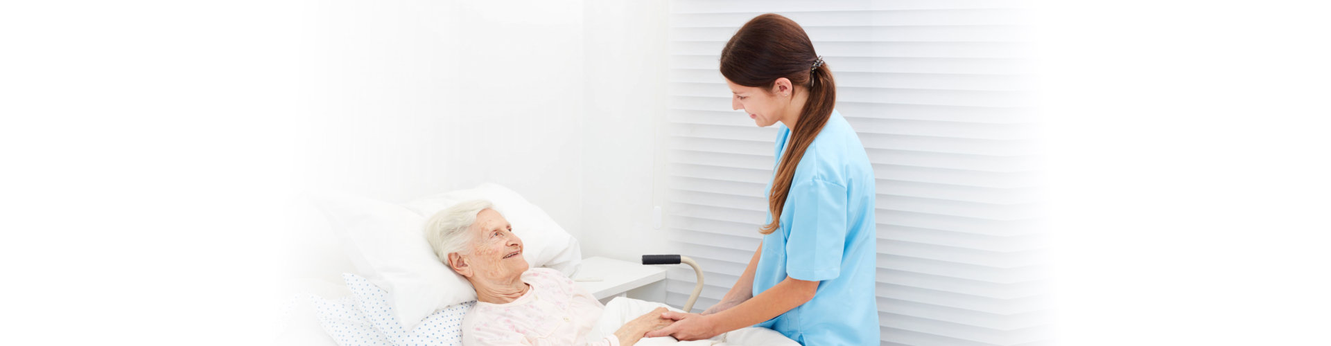 nurse assisting elderly woman