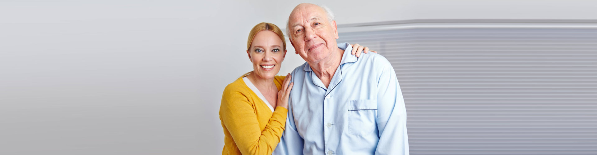 caregiver and elderly person smiling